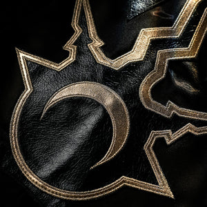 Honkai Star Rail Khaslana cosplay chest emblem detail shows gold linework over the black costume