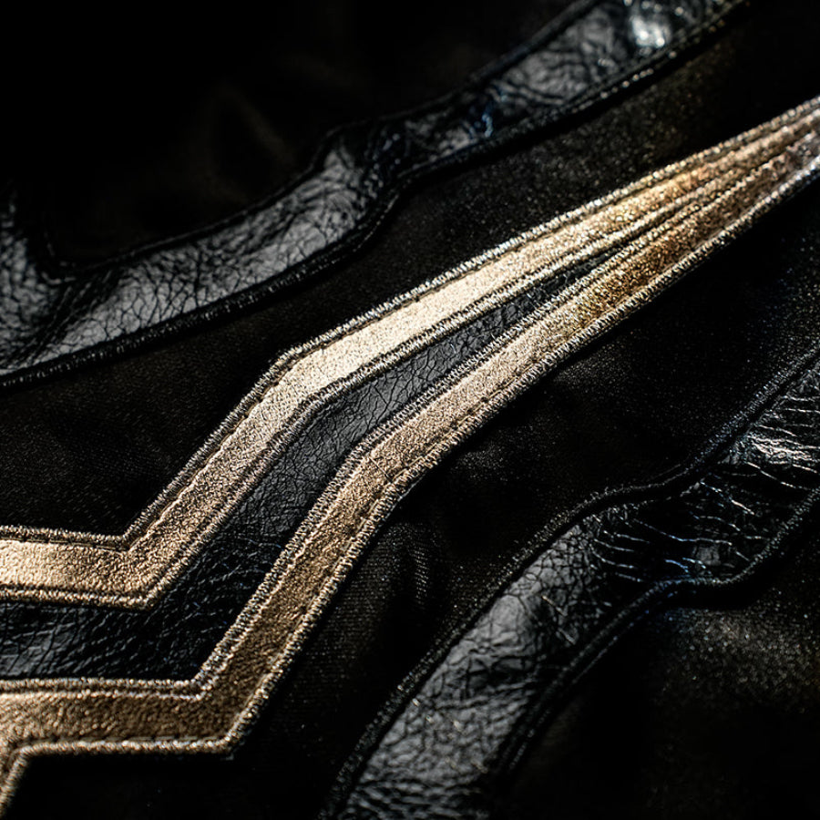 Honkai Star Rail Khaslana cosplay coat detail follows sharp gold embroidery across black fabric