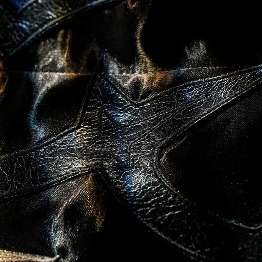 Honkai Star Rail Khaslana cosplay coat close-up shows textured black fabric shaped by stitched seams