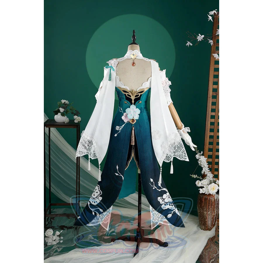 Honkai: Star Rail Ruan Mei cosplay costume gathers the open back, white shawl, and dark teal rear skirt panels.