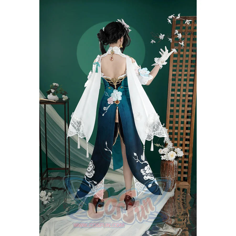 Honkai: Star Rail Ruan Mei cosplay costume reveals the open back cut, long teal panels, and white shawl from behind.