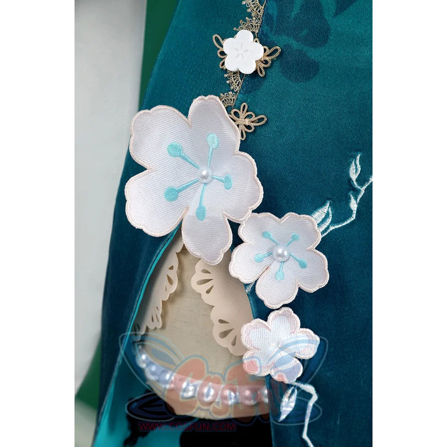 Honkai: Star Rail Ruan Mei cosplay costume skirt detail layers white blossom charms beside pearl trim and teal fabric.
