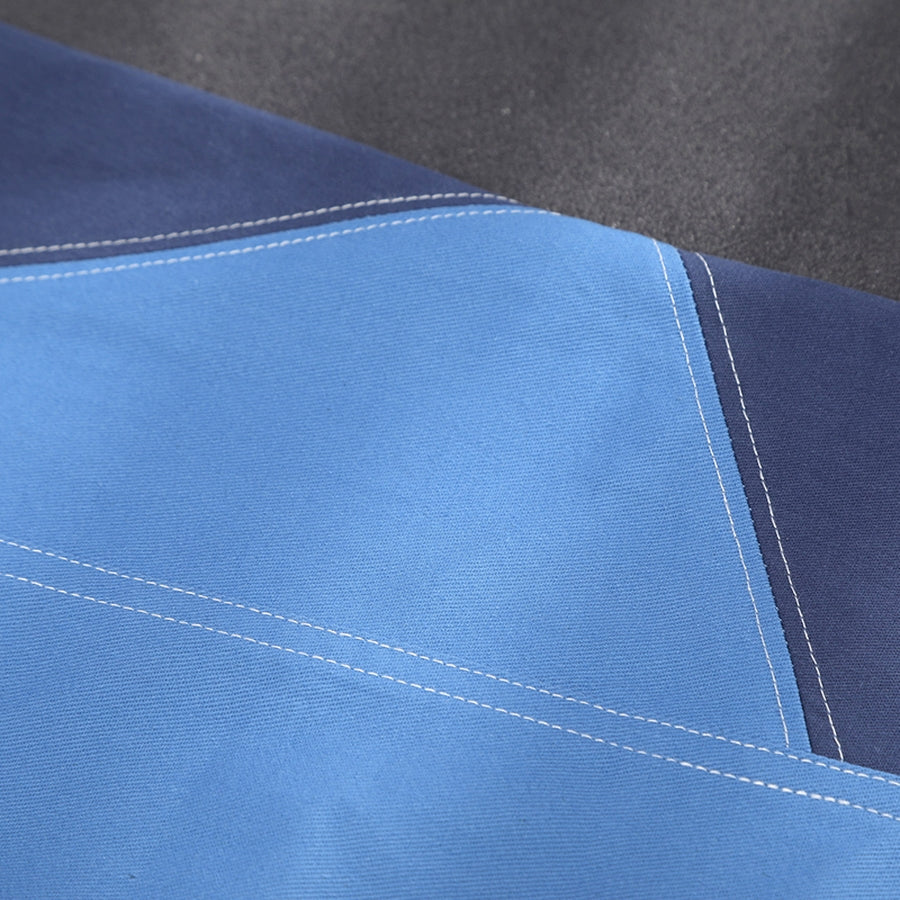 Human Torch Johnny Storm cosplay costume fabric layers light blue and dark blue sections beside clean white top stitching.
