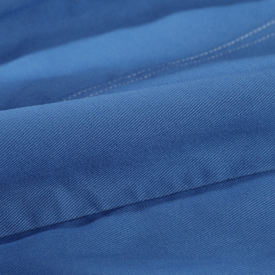 Human Torch Johnny Storm cosplay costume fabric close up reveals the dense weave of the durable blue cotton twill textile.