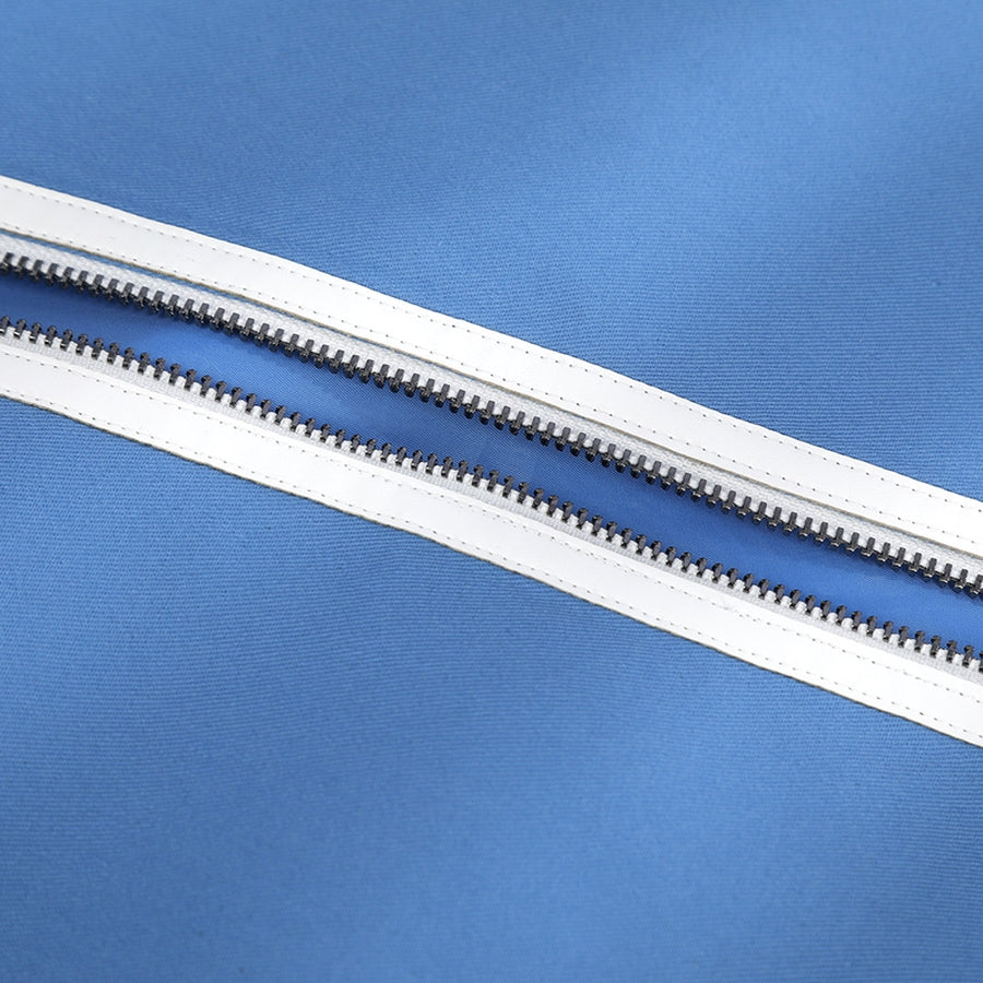 Human Torch Johnny Storm cosplay costume fabric layers gather at a secure silver-tone zipper track on blue textile.