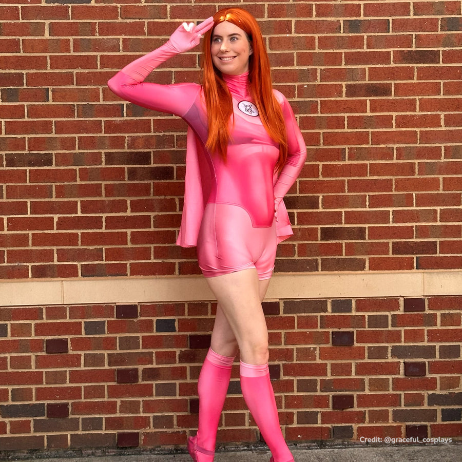 Invincible Atom Eve cosplay costume standing view sets a pink jumpsuit below the sheer shawl and knee socks.