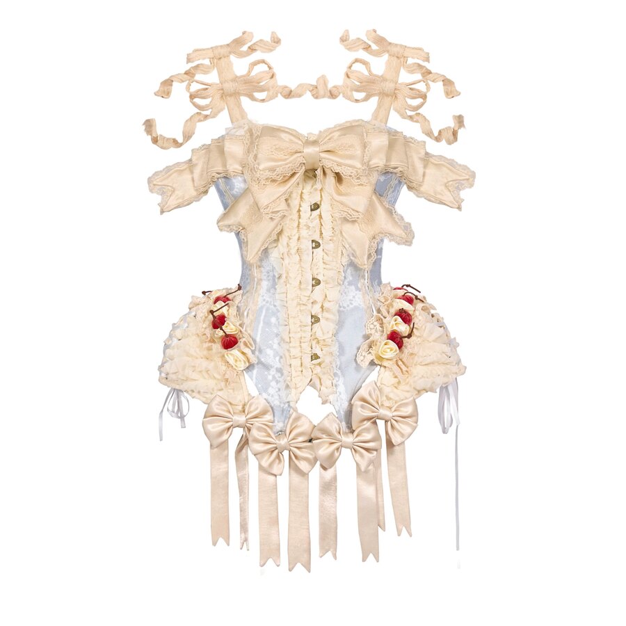 Flat lay of a cream lace bodice with blue center panel, bows, buttons, and ribbon streamers