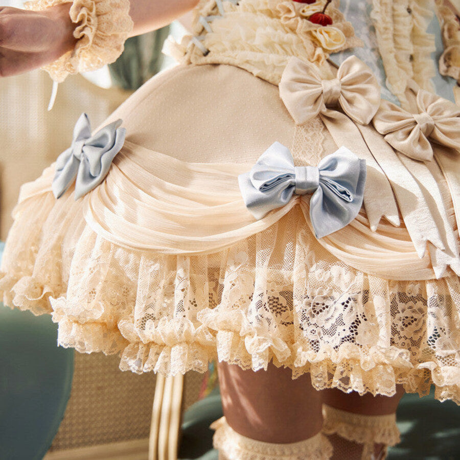 Close-up of the Lace Bow Skirt item with blue satin bows, gathered mesh, floral lace, and cream ruffles