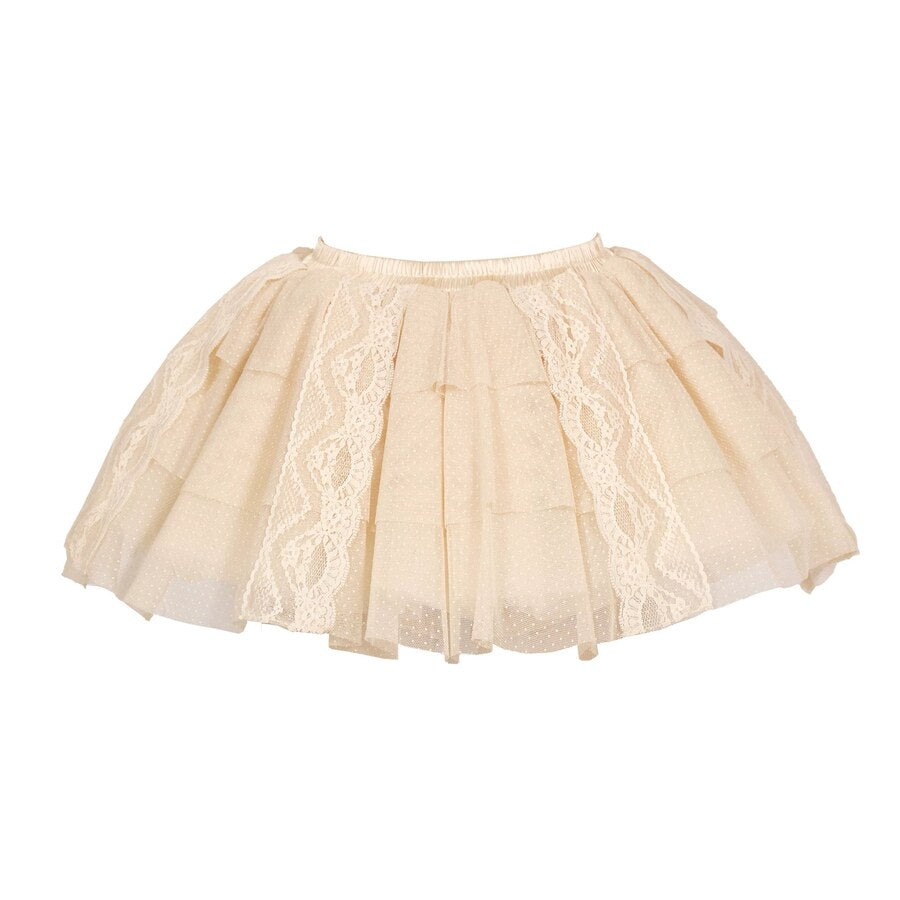Flat lay of a beige lace skort with dotted mesh layers and vertical lace panels