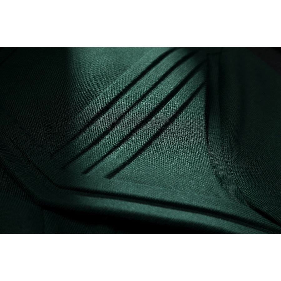 Latverian Witch cosplay costume frames dark green fabric with precise linear pleats that enhance the textured surface detail.