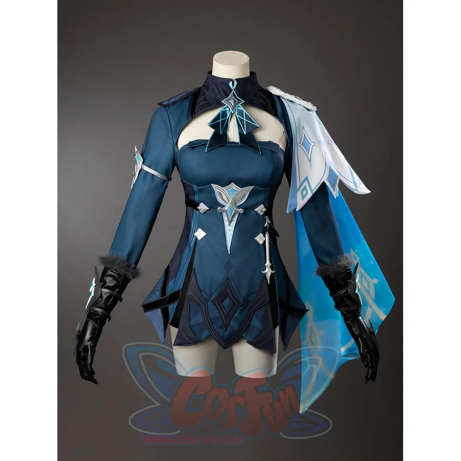 Lumine cosplay costume angled view shows pointed hem panels beneath a turquoise back drape beside black gloves.