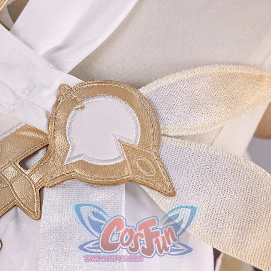 Close-up of Genshin Impact Lumine cosplay costume shoulder accessory with gold frame, white inset, and cream fabric