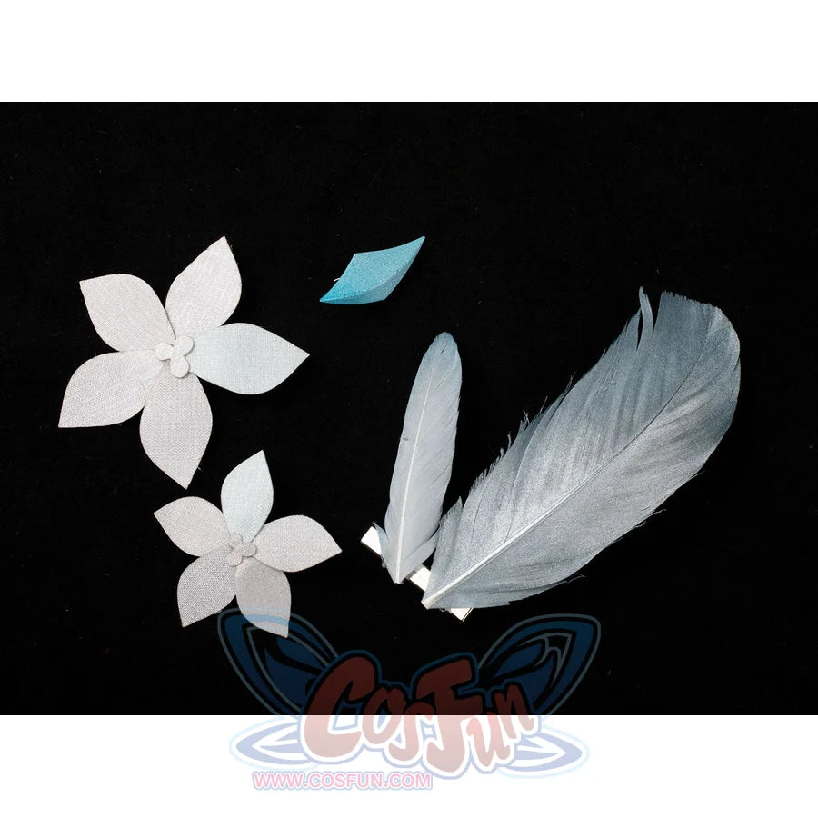Lumine cosplay decorative pieces flat lay with pale flowers beside feather-like shapes and turquoise accents.