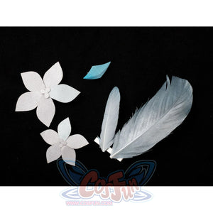 Lumine cosplay decorative pieces flat lay with pale flowers beside feather-like shapes and turquoise accents.
