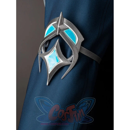 Lumine cosplay sleeve ornament close-up with silver-tone curves and turquoise insets on dark teal fabric.