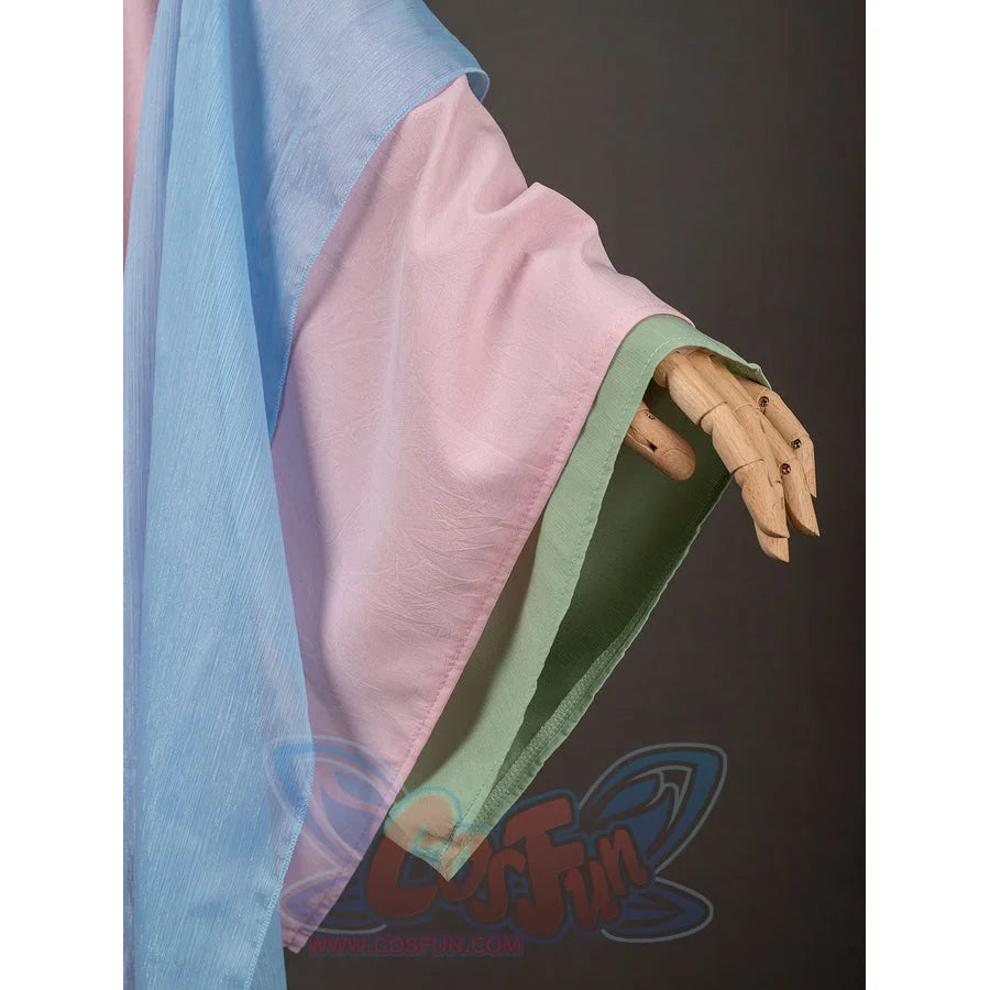 The Apothecary Diaries Maomao cosplay costume layers pink and blue sleeve panels around green cuffs.