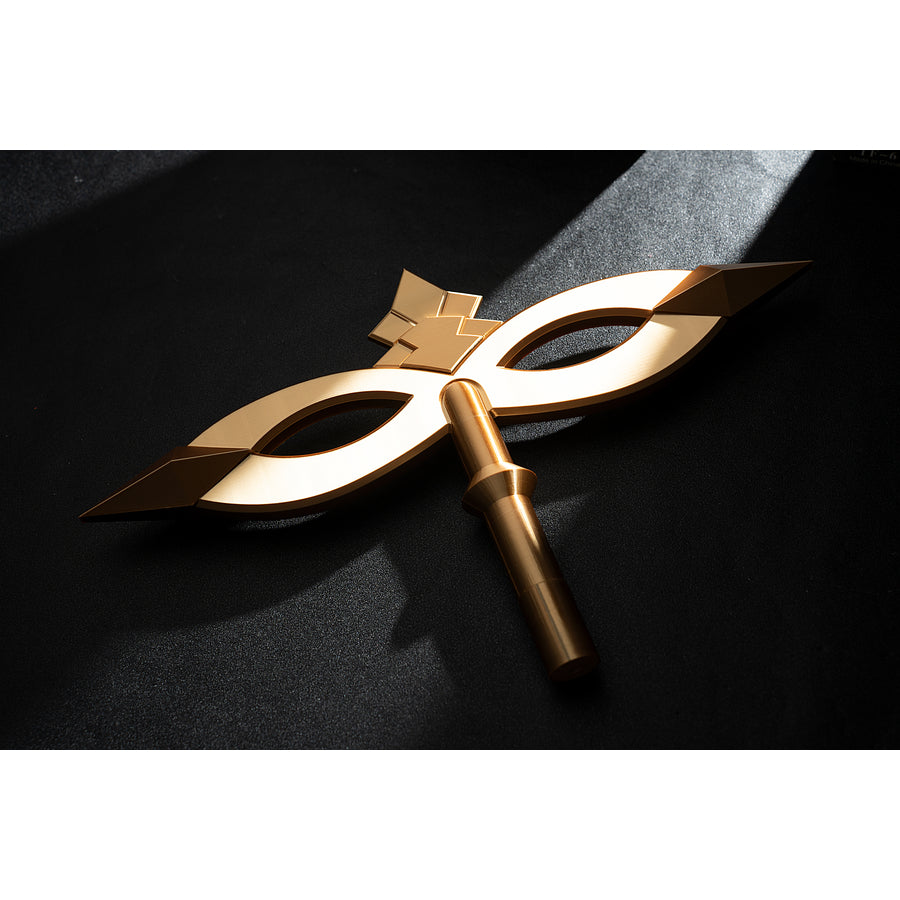 Genshin Impact Marionette Sandrone cosplay costume lays the gold-tone mask prop across black fabric.