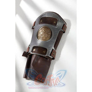 Masters of the Universe He-Man cosplay wristband flat lay shows gray armor framing a round medallion over brown panels