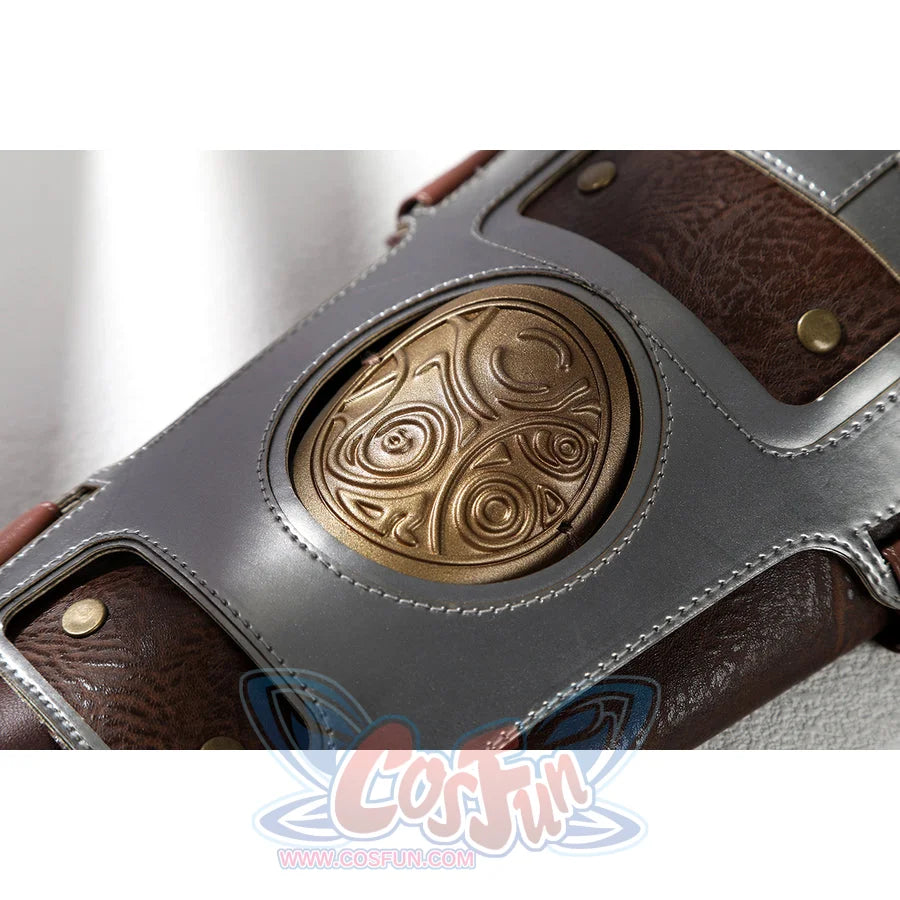 Masters of the Universe He-Man cosplay wristband medallion close-up centers the gold-tone carved disk in gray trim