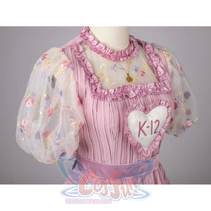 Melanie Martinez K-12 Cry Baby cosplay bodice angle sets the K-12 heart patch amid pink ruffles.