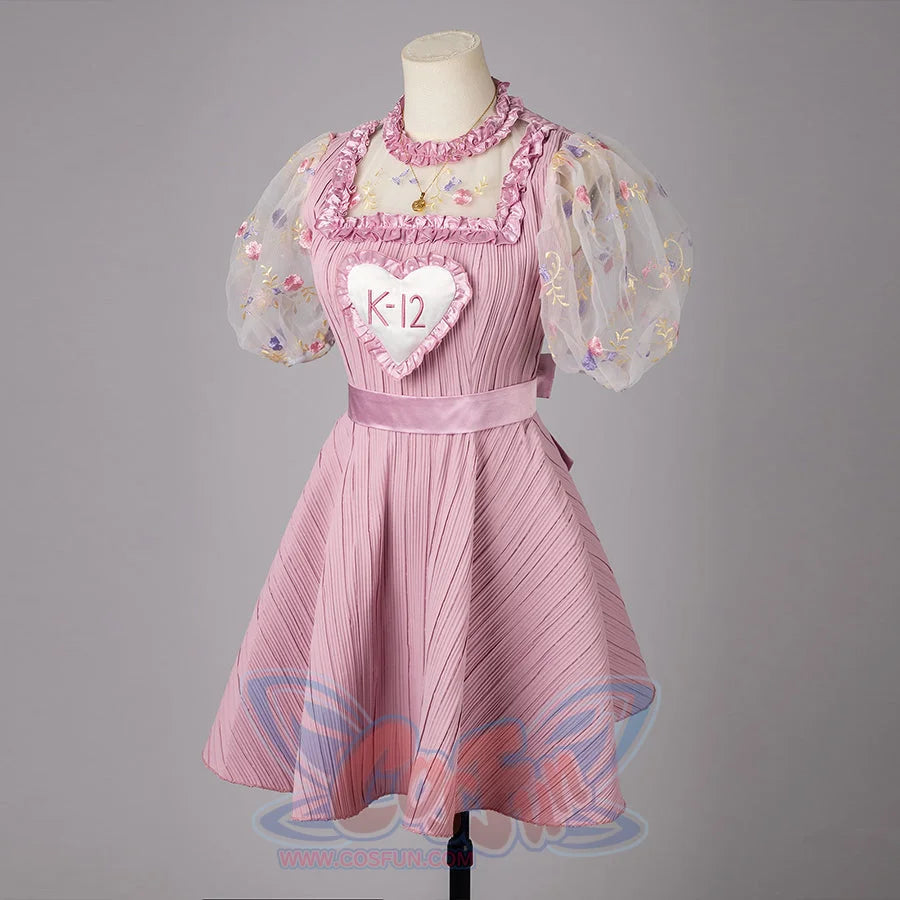 Melanie Martinez K-12 Cry Baby cosplay dress angles the heart bib over a pink skirt and satin belt.