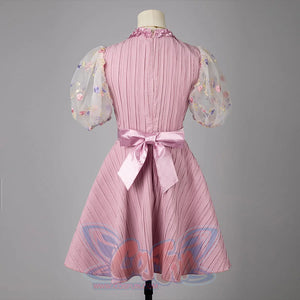 Melanie Martinez K-12 Cry Baby cosplay dress back view ties a satin bow over a pleated pink bodice.