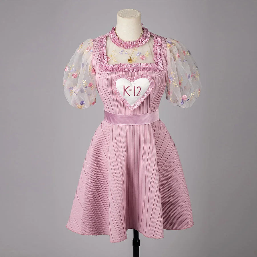 COSFUN Melanie Martinez K-12 Cry Baby cosplay dress layers a pink pleated skirt under sheer puff sleeves.