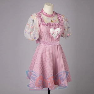 Melanie Martinez K-12 Cry Baby cosplay dress side view balances sheer sleeves and a flared pink skirt.