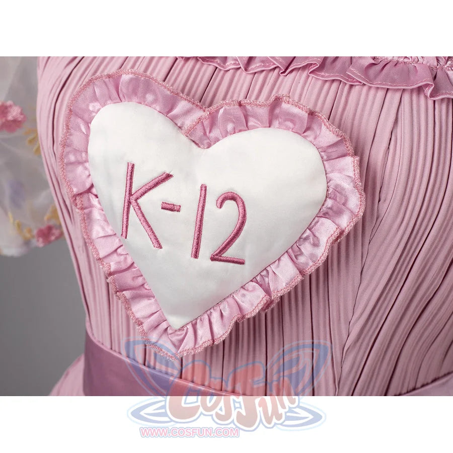 Melanie Martinez K-12 Cry Baby cosplay heart patch detail centers the K-12 emblem on pink pleated fabric.