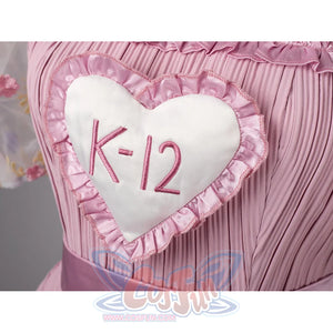 Melanie Martinez K-12 Cry Baby cosplay heart patch detail centers the K-12 emblem on pink pleated fabric.