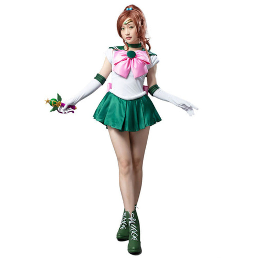 Makoto Kino cosplay costume frames a pink chest bow against a white top layered over a green pleated miniskirt.