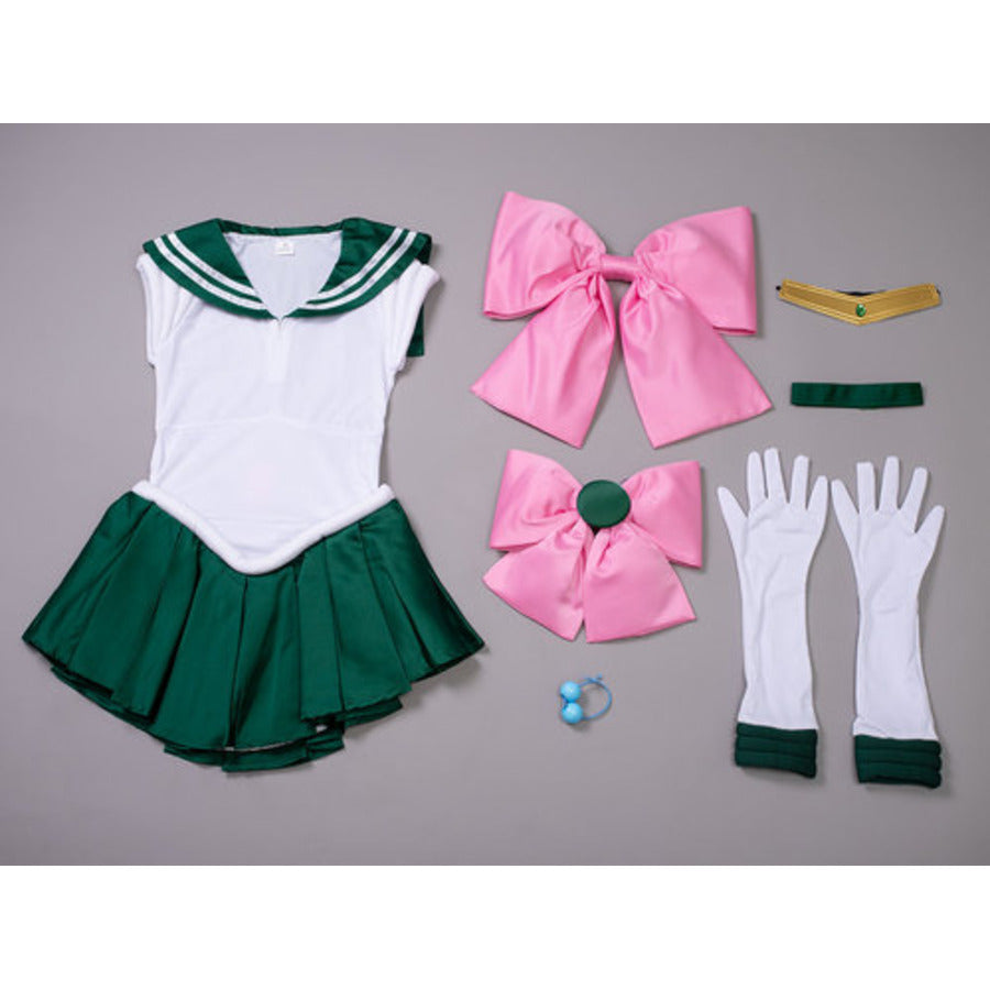 Makoto Kino cosplay costume flat lay gathers two large pink bows beside white gloves and a gold tiara with green trim.