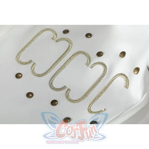 Close-up of Nico Robin cosplay costume white hat with gold embroidered swirl trim and bronze studs