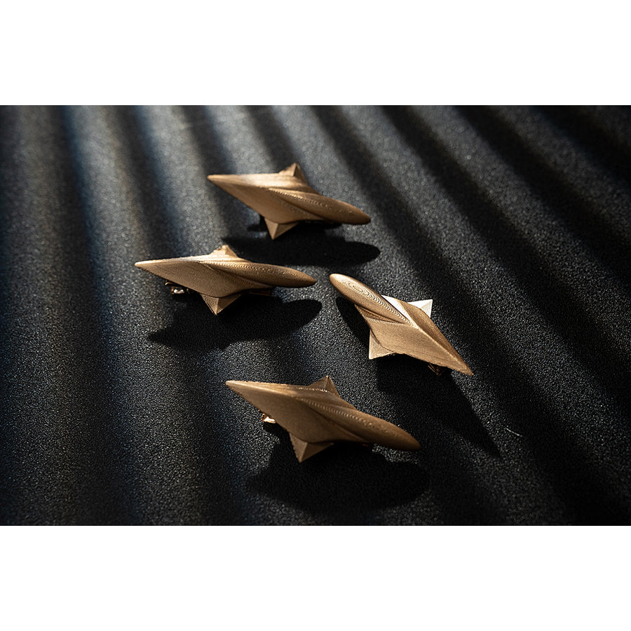Genshin Impact Noelle cosplay back decorations appear as angular gold-tone accessory pieces.