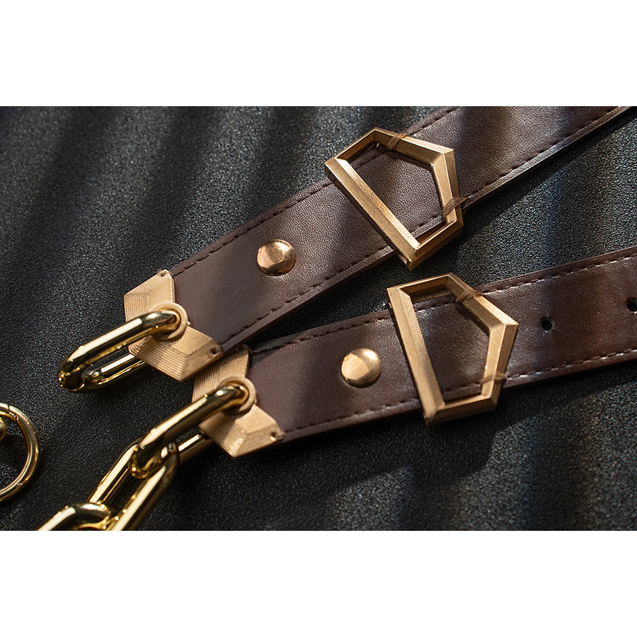 Genshin Impact Noelle cosplay belt detail shows brown straps, gold-tone buckles and chain accents.