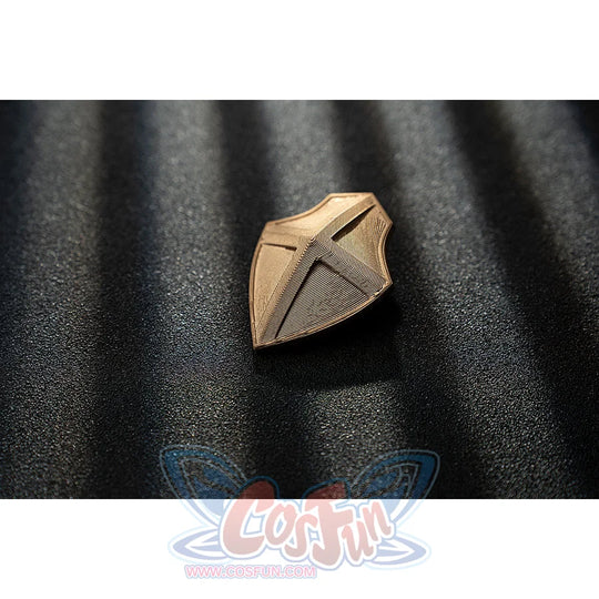 Genshin Impact Noelle cosplay gold-tone shield accessory shows an angular leaf cutout design.