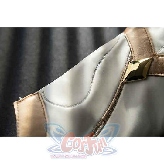 Genshin Impact Noelle cosplay leg guard buckle detail sets gold trim around white armor panels.