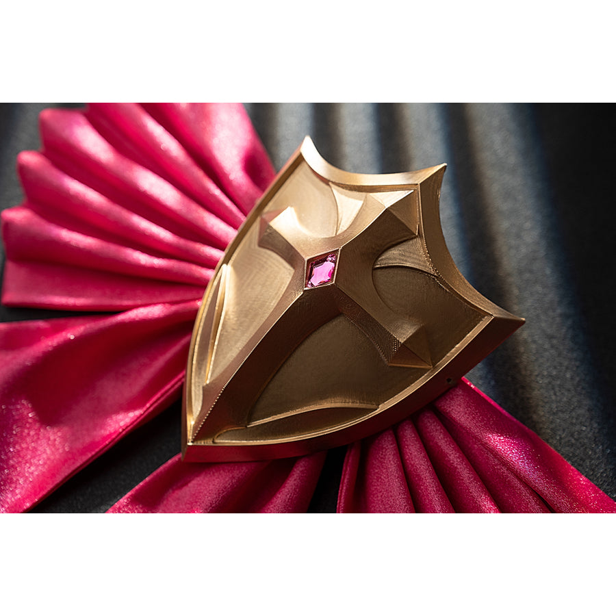 Genshin Impact Noelle cosplay shield decoration close-up sits over pleated pink satin fabric.