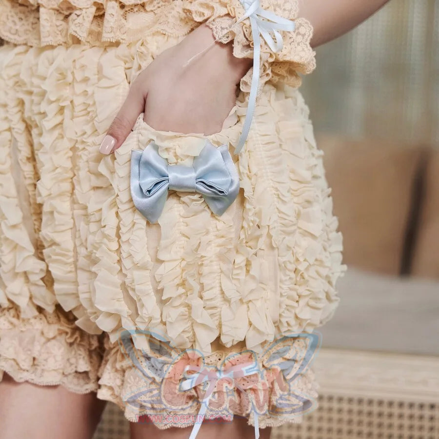 Close-up of the pumpkin bloomers pale blue satin bow, cream lace trim, and ruffled fabric texture