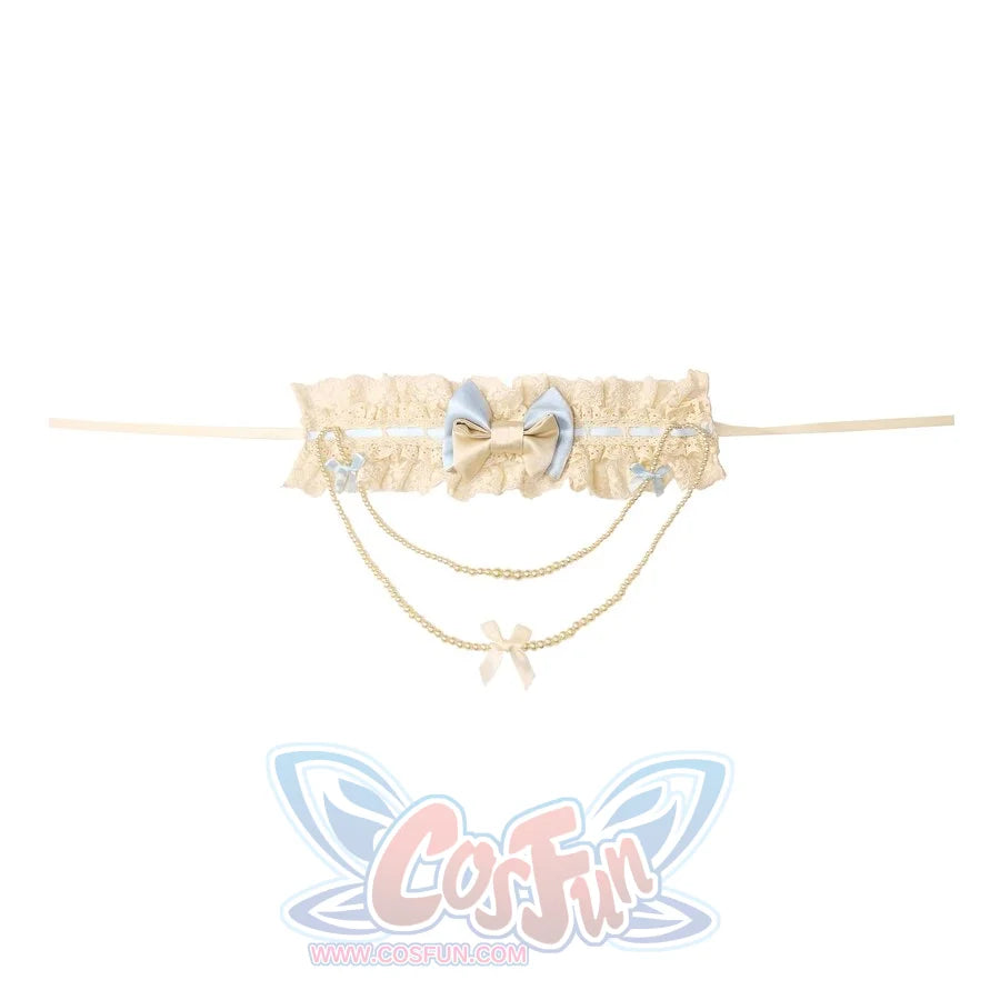 Flat lay of the Bow Pearl Necklace item with blue bow, bow charms, and dangling chain details