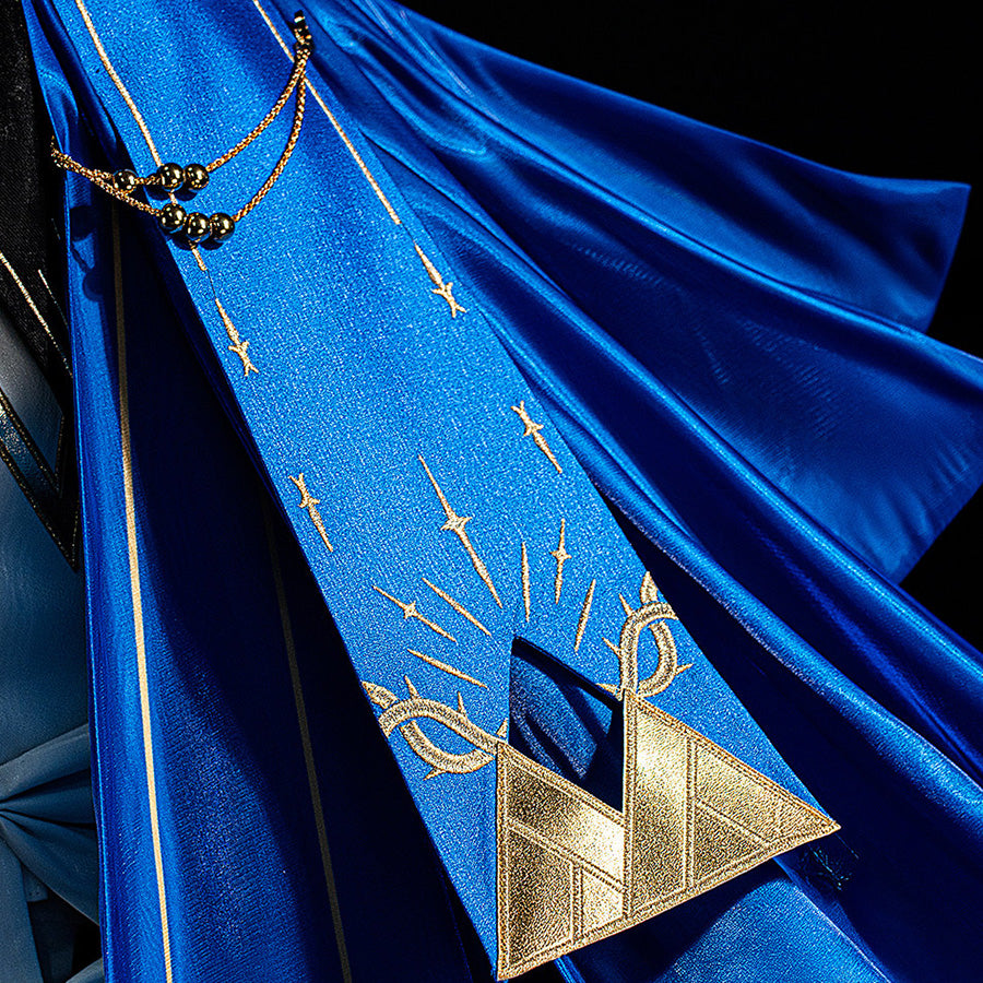 Wuthering Waves Phoebe cosplay cape detail pairs blue satin folds with a gold-tone geometric ornament