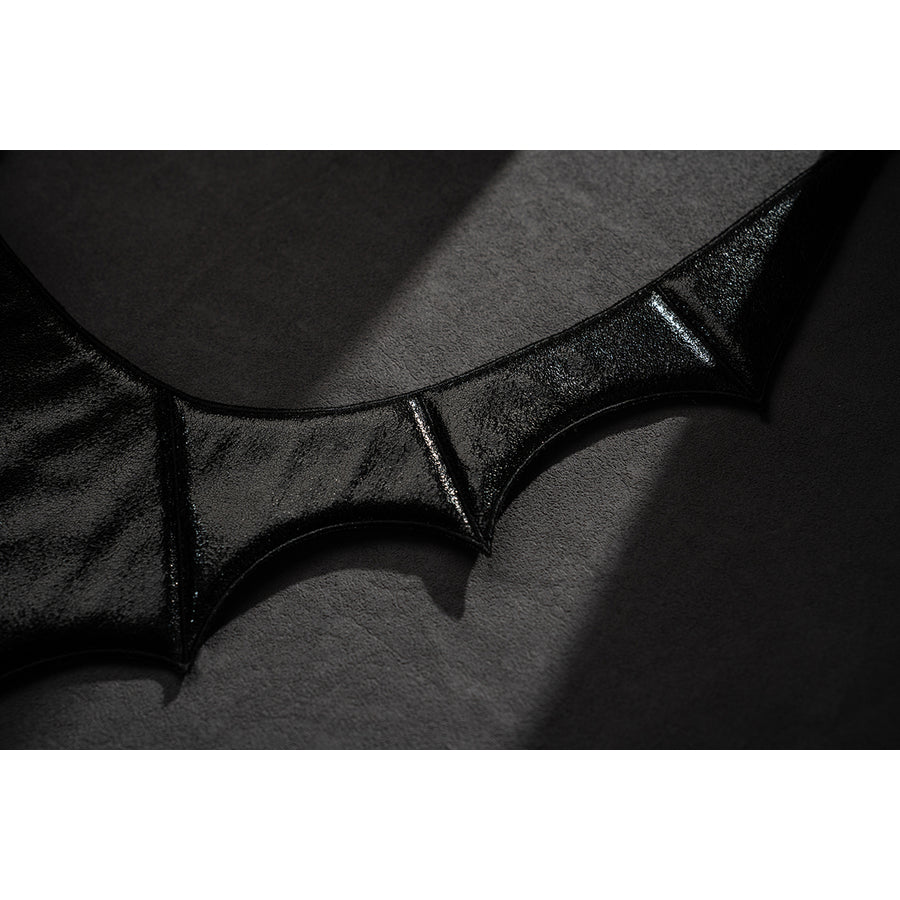 Wuthering Waves Phrolova cosplay bat-wing trim detail shows black pointed edging and stitch lines.