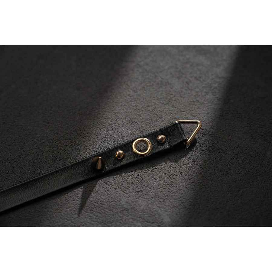 Wuthering Waves Phrolova cosplay belt strap detail shows gold-tone eyelets on black faux leather.
