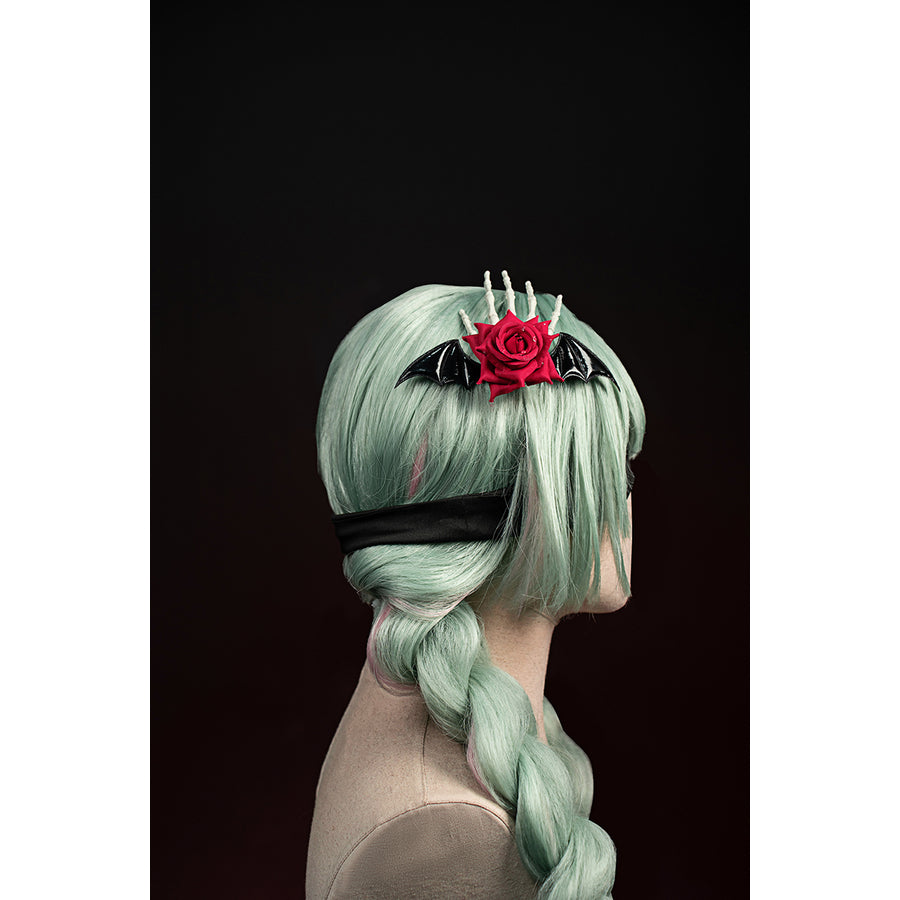 Wuthering Waves Phrolova cosplay rose headpiece detail shows a red flower set beside silver-tone spikes.