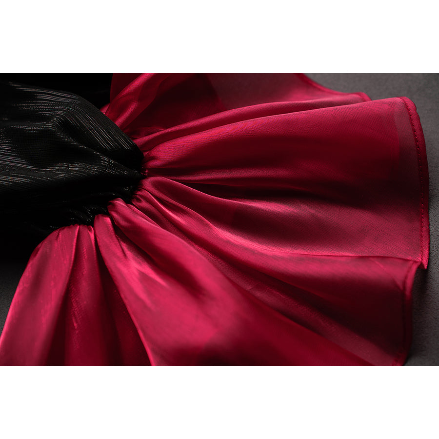 Wuthering Waves Phrolova cosplay sleeve cuff detail gathers red satin beneath glossy black fabric.
