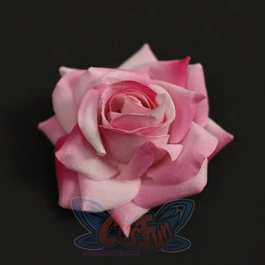 Close-up of Re:Zero Emilia cosplay costume pink rose headpiece with layered petals on a dark background