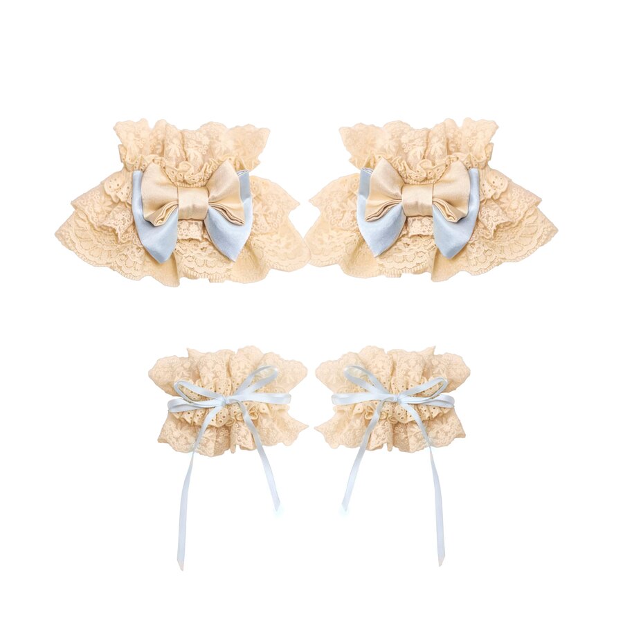 Flat lay of cream lace ruffle cuffs with blue bows and ribbon ties
