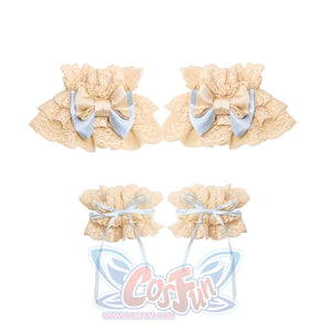 Flat lay of the Bow Sleeve Cuffs item with cream lace ruffles, blue bows, and ribbon ties