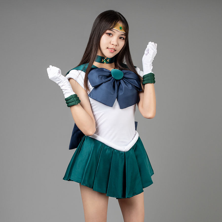 Sailor Moon Sailor Neptune cosplay costume angled pose lifts white gloves beside a navy bow and emerald pleats.