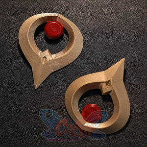Flat lay of Sandrone cosplay costume gold ornaments with red round centers and curved metal-look shapes